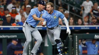 HOUSTON, TEXAS – JUNE 01: Taylor Walls #6 of the Tampa Bay Rays is held back by a coach after returning from the dugout after being ejected in the ninth inning against the Houston Astros at Daikin Park on June 01, 2025 in Houston, Texas. (Photo by Tim Warner/Getty Images)