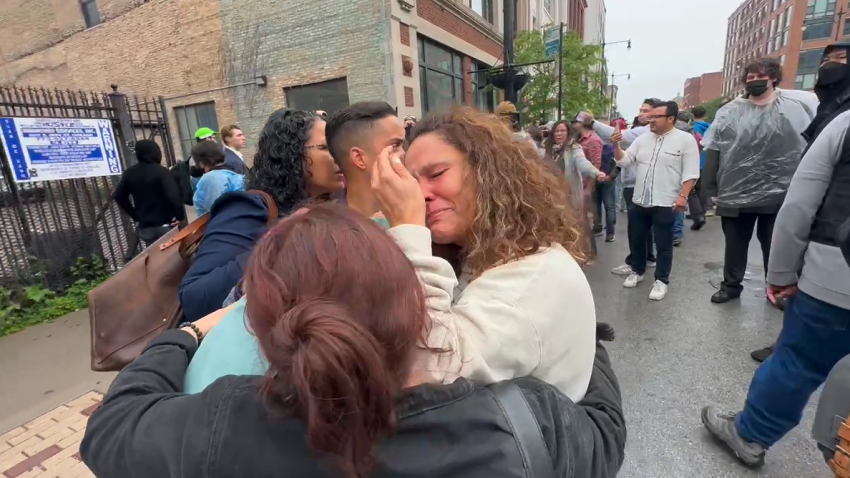 A woman is seen huddling with demonstrators after an immigration protest in Chicago’s Motor Row District on June 4.